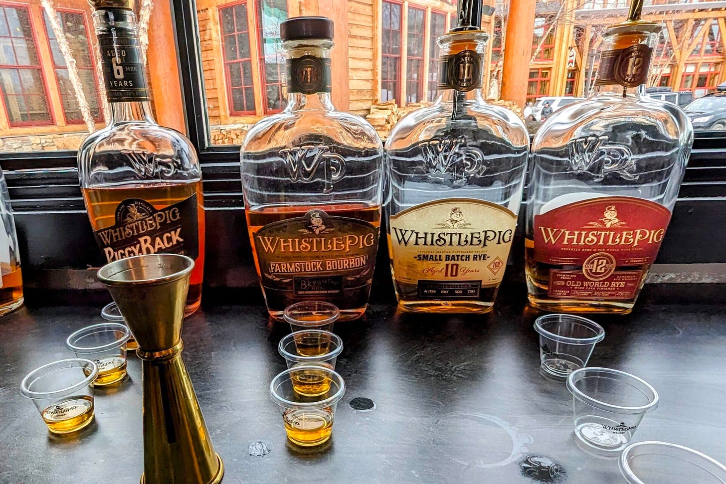 WhistlePig products with plastic tasting cups