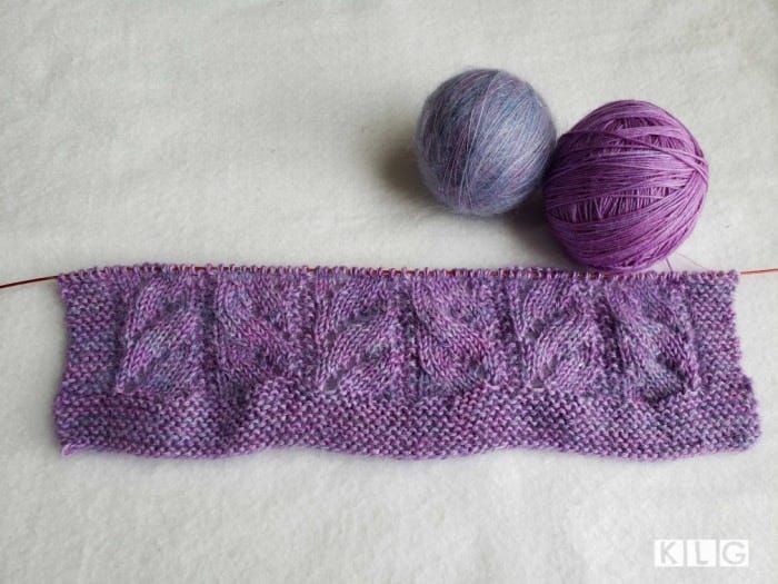 The two yarns wound into balls and the beginning of the Chasing Light Shawl garter stitch border and lace pattern