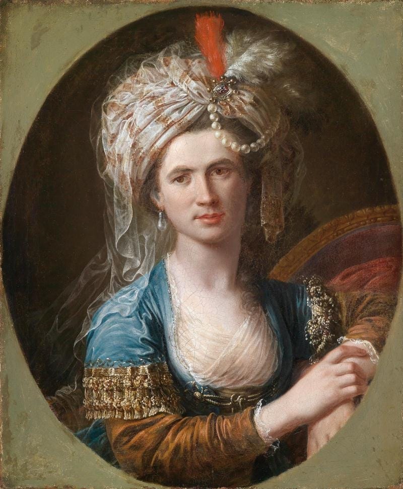 A painting of Chevaliere D'Eon by Angelica Kaufman. The trans woman in the painting is wearing a white bonnet, light blue dress with copper sleaves. Lots of lace trim around the edges of clothes and wears pearls.