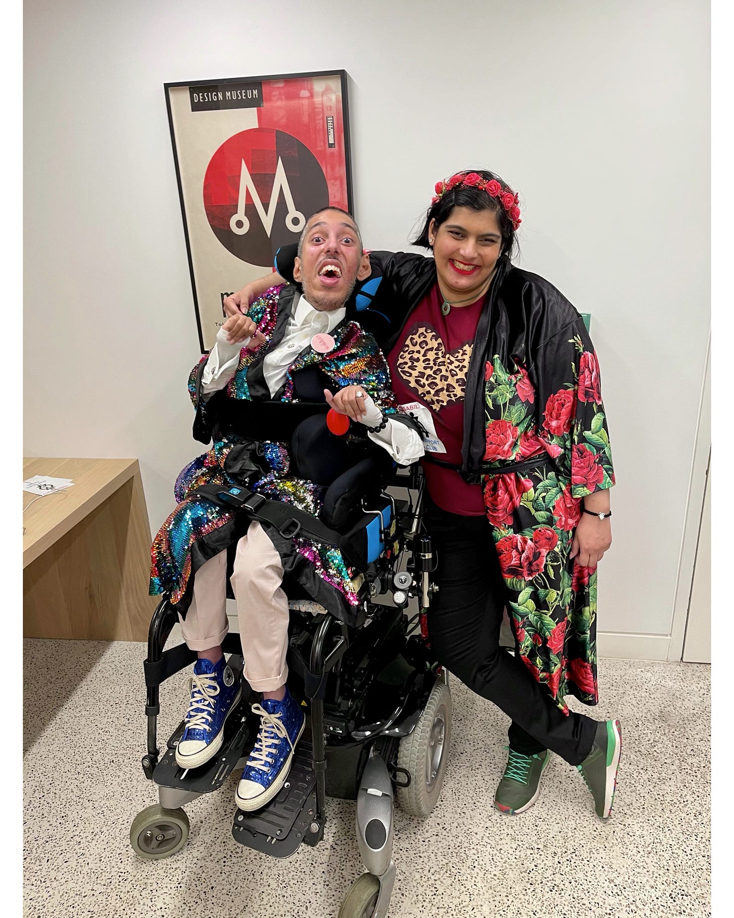 IMAGE 3 DESCRIPTION: Photo of Sana with Sulaiman both dressed stylishly post Sulaiman’s talk in his private Green Room at the Design Museum. Both are smiling and joyful.