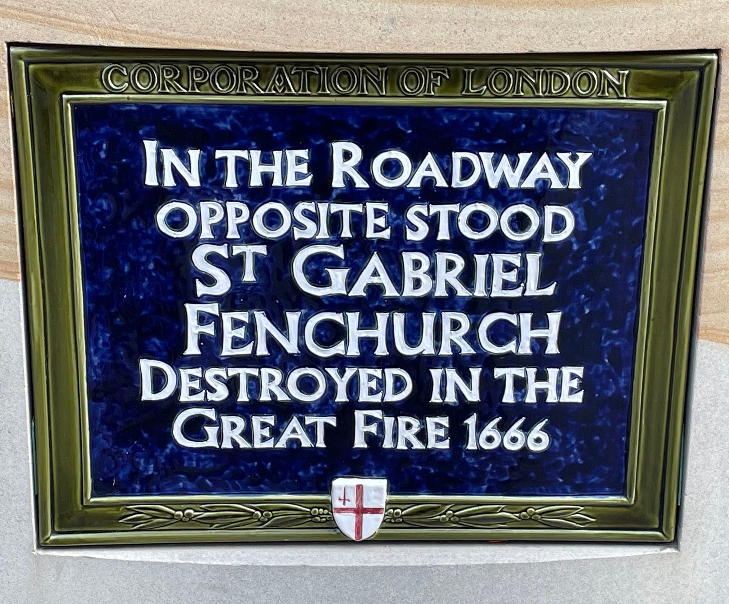 A blue ceramic plaque that reads “In the roadway opposite stood St Gabriel Fenchurch destroyed in the Great Fire 1666.”