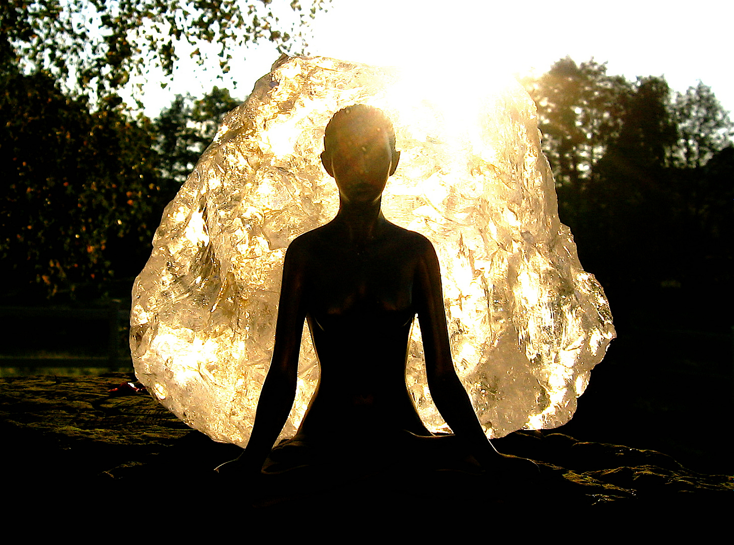 photo of person meditating with golden aura surrounding .