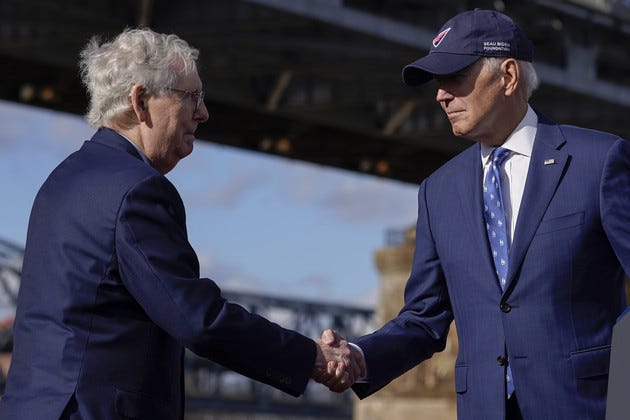 President Joe Biden shakes hands with Senate Minority Leader Mitch McConnell.