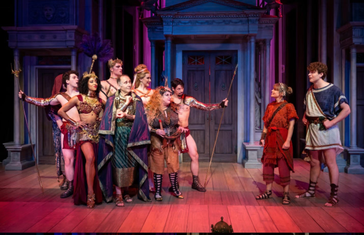 A group of people in clothing on a stage

Description automatically generated
