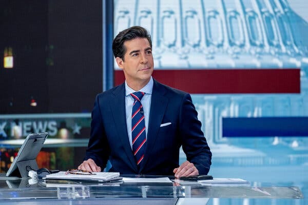 Jesse Waters, wearing a dark blue suit and blue tie with red stripes, sits at a glass table  while anchoring a TV show, with a screen showing the U.S. Capitol behind him.