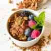 bowl of granola with berries and mint