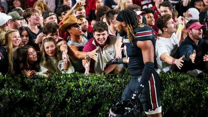 Nov 18, 2023; Columbia, South Carolina, USA; South Carolina Gamecocks students high five linebacker Debo Williams (0) following their win over the Kentucky Wildcats at Williams-Brice Stadium. 