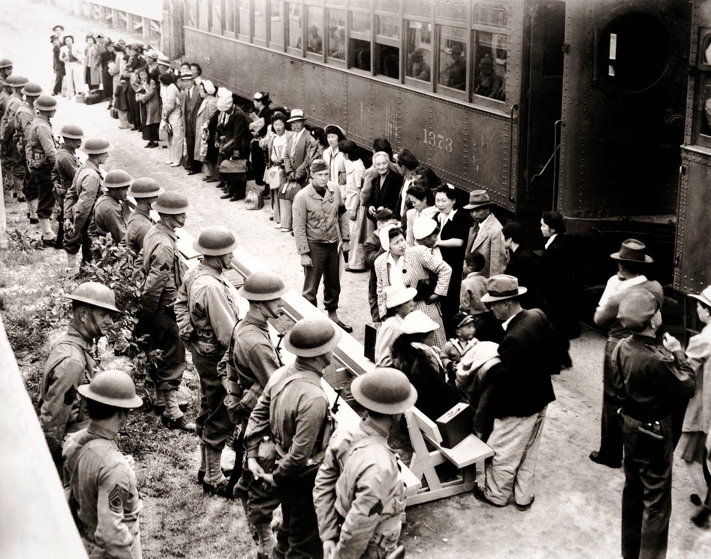 Japanese citizens of the United States en route to their internment at the Santa Anita racetrack, California during World War II, April 1942