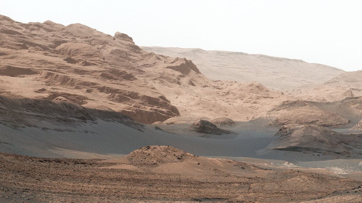 rolling hills of wind-blown red rock and dust rolling hills of wind-blown red rock and dust