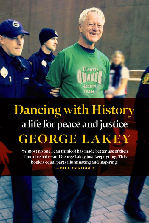George Lakey, wearing green Earth Quaker Action Team t-shirt and a big smile, is led away under arrest by two police officers in blue uniforms.