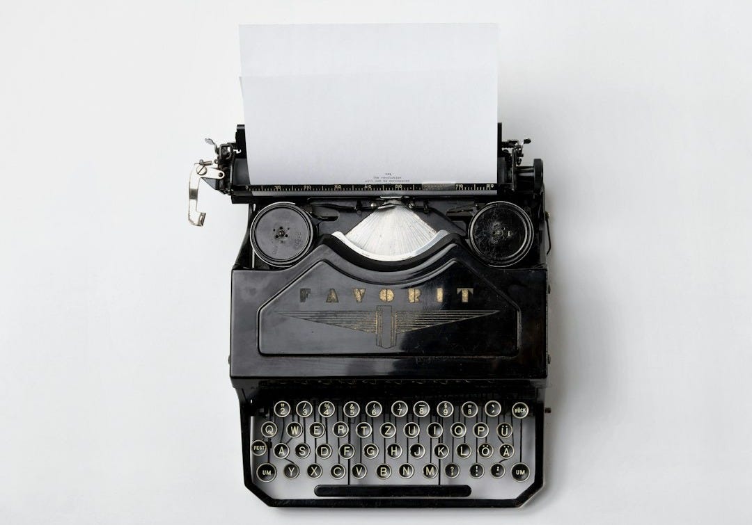 black Fayorit typewriter with printer paper