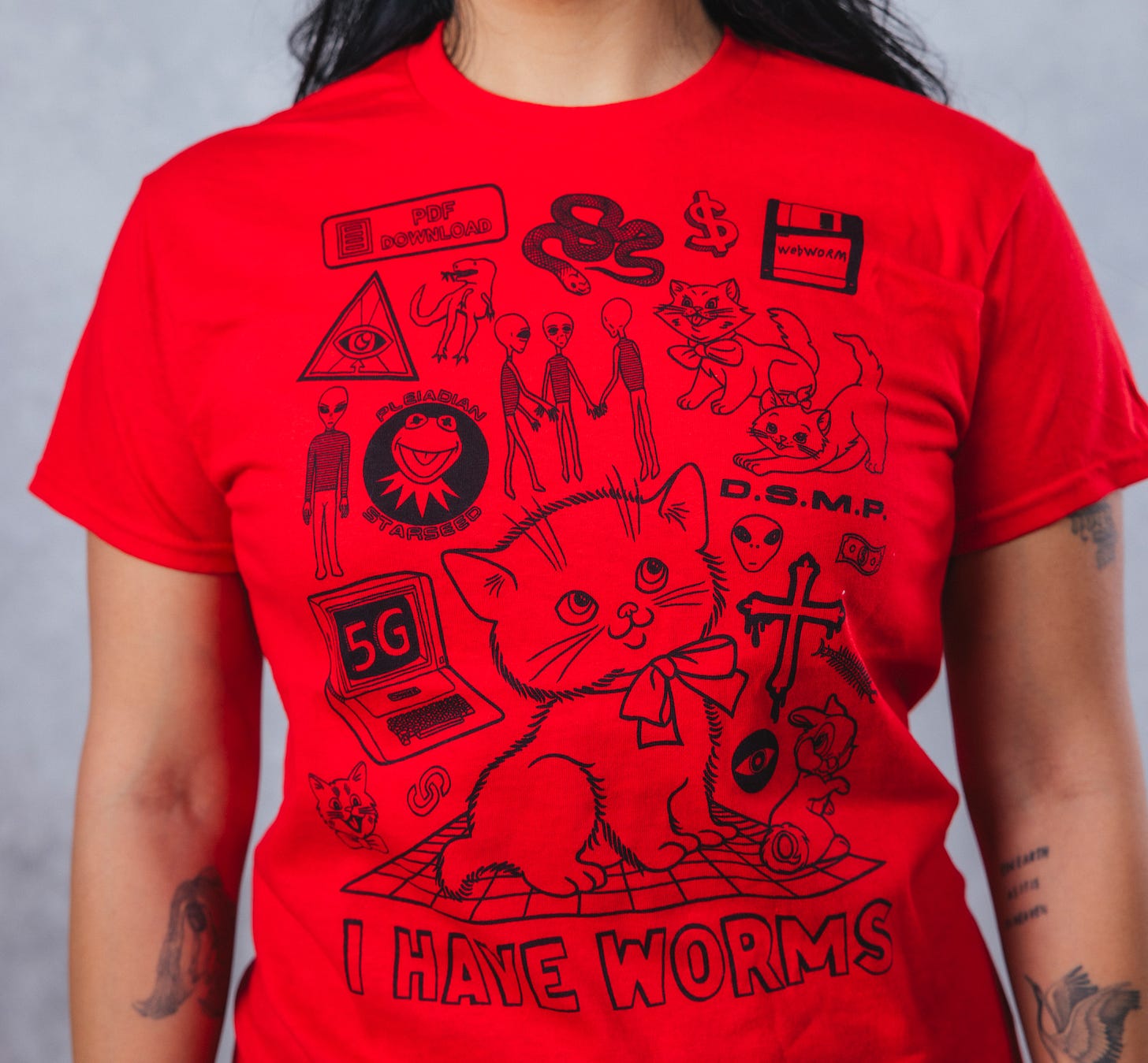 This is a red tee with black icons on it that are all Webworm related, from cats to aliens to floppy discs and 5G warnings!