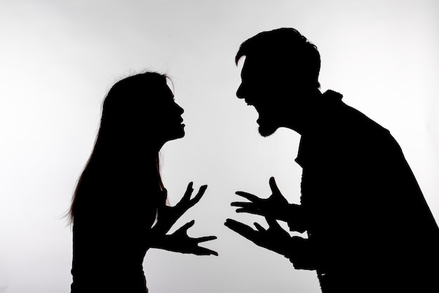 Premium Photo | Man and woman face to face screaming shouting each other  dispute silhouette