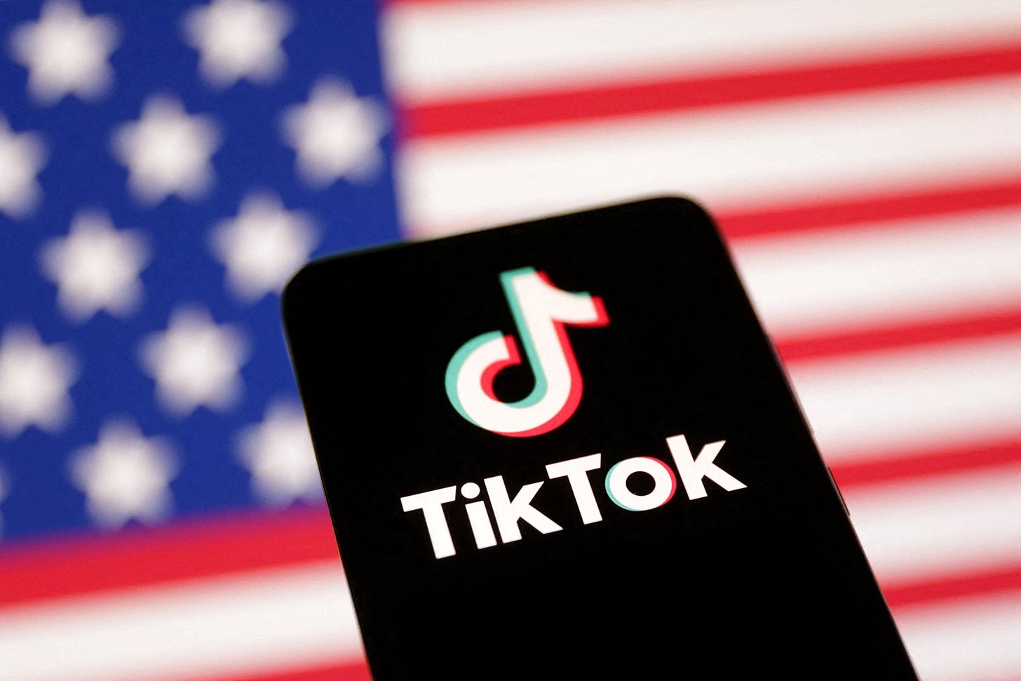 Illustration shows U.S. flag and TikTok logo