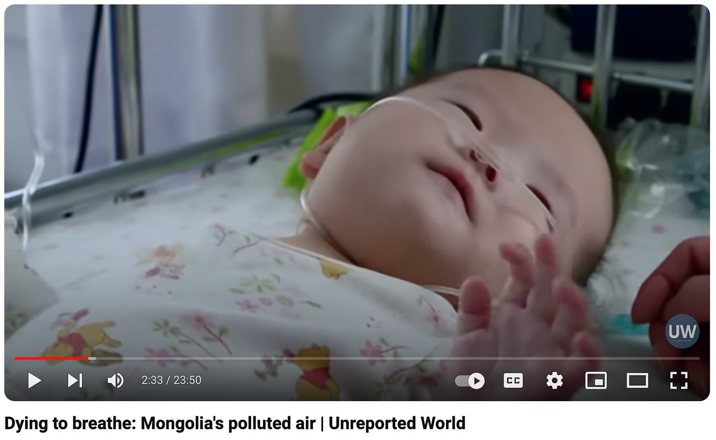 A still from a video showing a baby in an incubator with a breathing tube