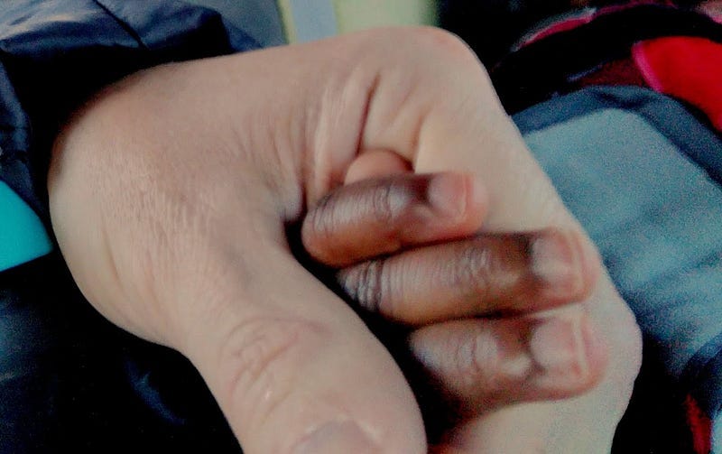 One of my most beloved pictures of me and my son. A month after he came to our house, I had to go on a trip. This is a picture of him holding my hand while my wife drove me to the airport.