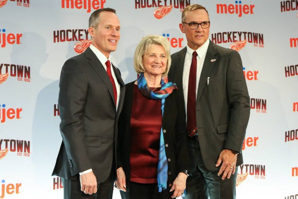 From the left, Detroit Red Wings Governor, President, and CEO Christopher Illitch, Marian Illitch, and Steve Yzerman pose for photographs during a...