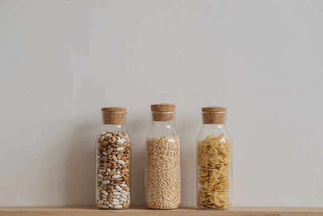 dry foods like beans and pasta sorted into separate glass containers