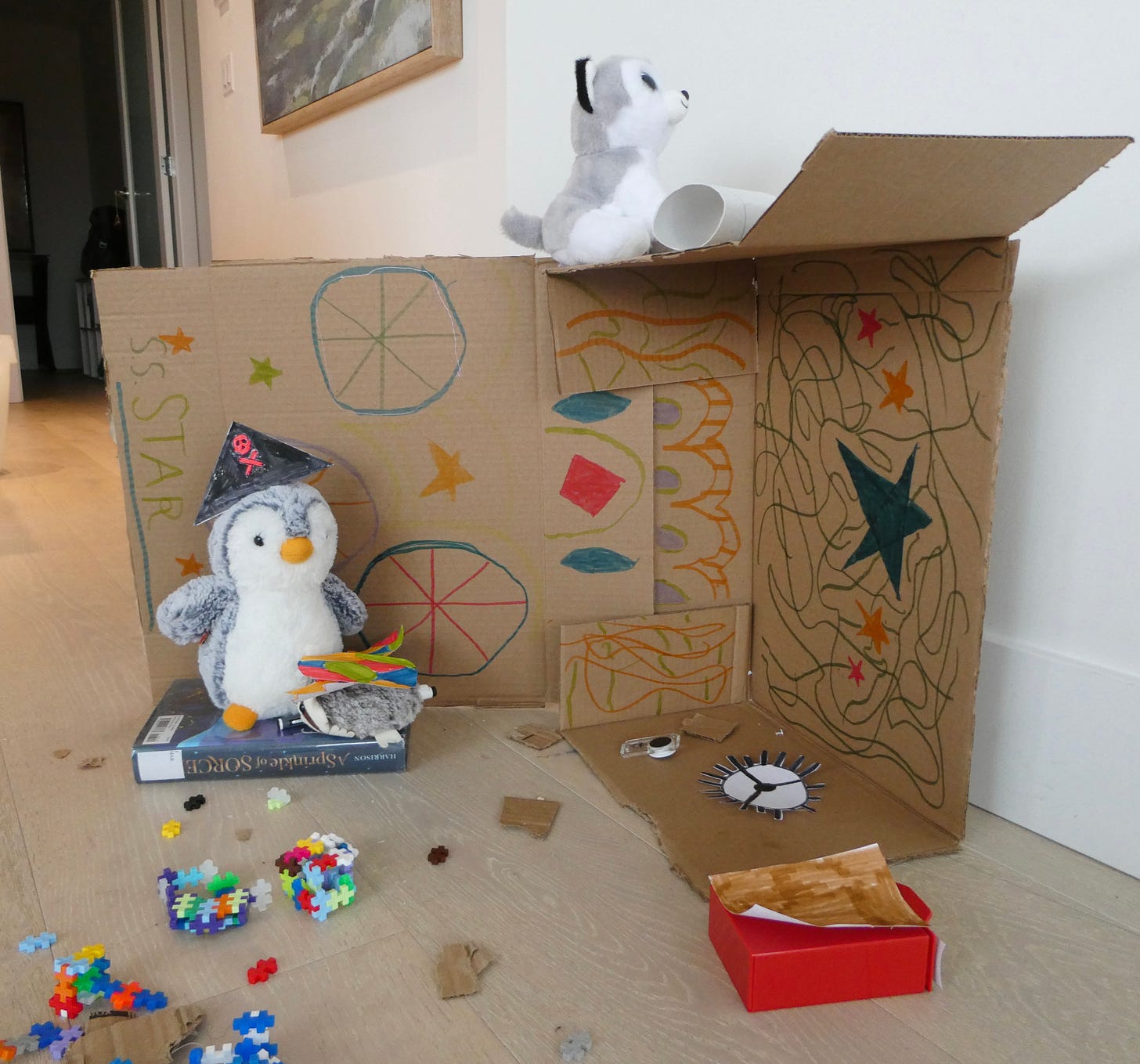 stuffed animals and a cardboard backdrop decorated as pirate ship