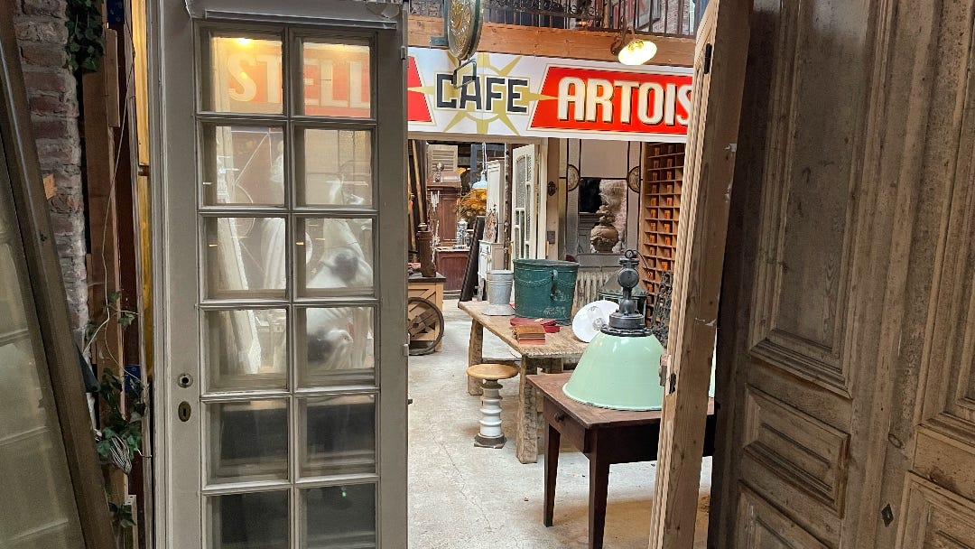 a shop with old doors, chairs, etc