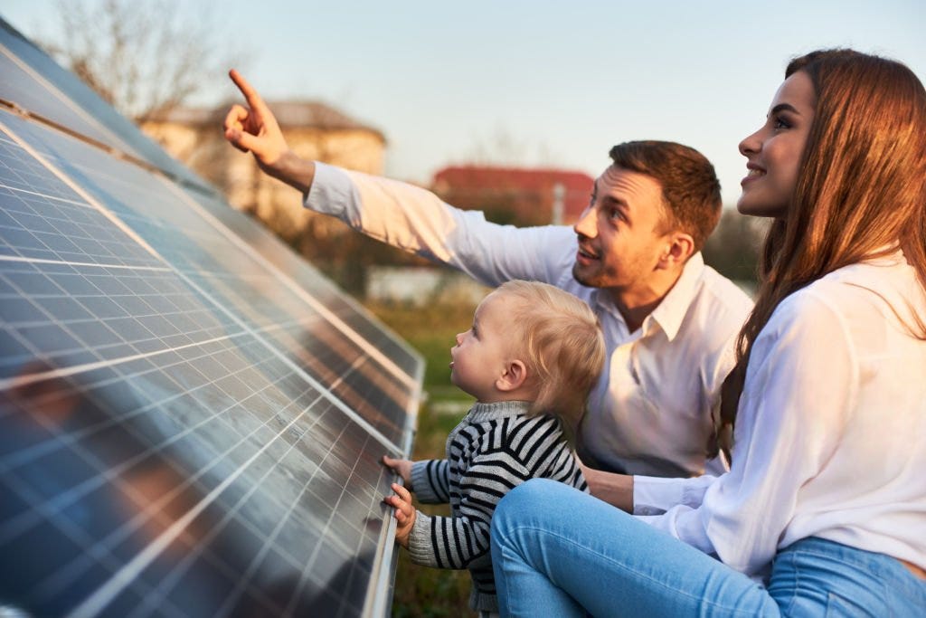 Image of a happy family with their solar installation