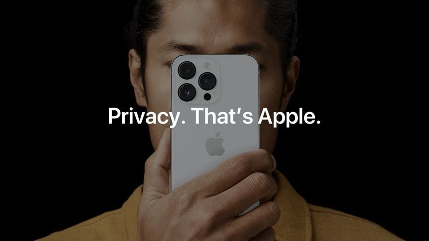An Apple advertisement showing a person holding an iPhone in front of their face. Text reads 'Privacy. That's iPhone'