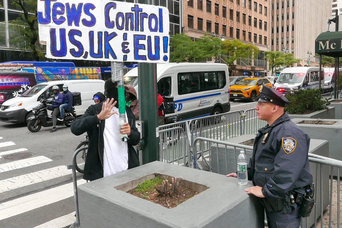 A masked man holds an anti-Jewish sign at a protest near the Israeli consulate in New York on Oct. 17, 2023. Photo by Joe Tabacca/Shutterstock.