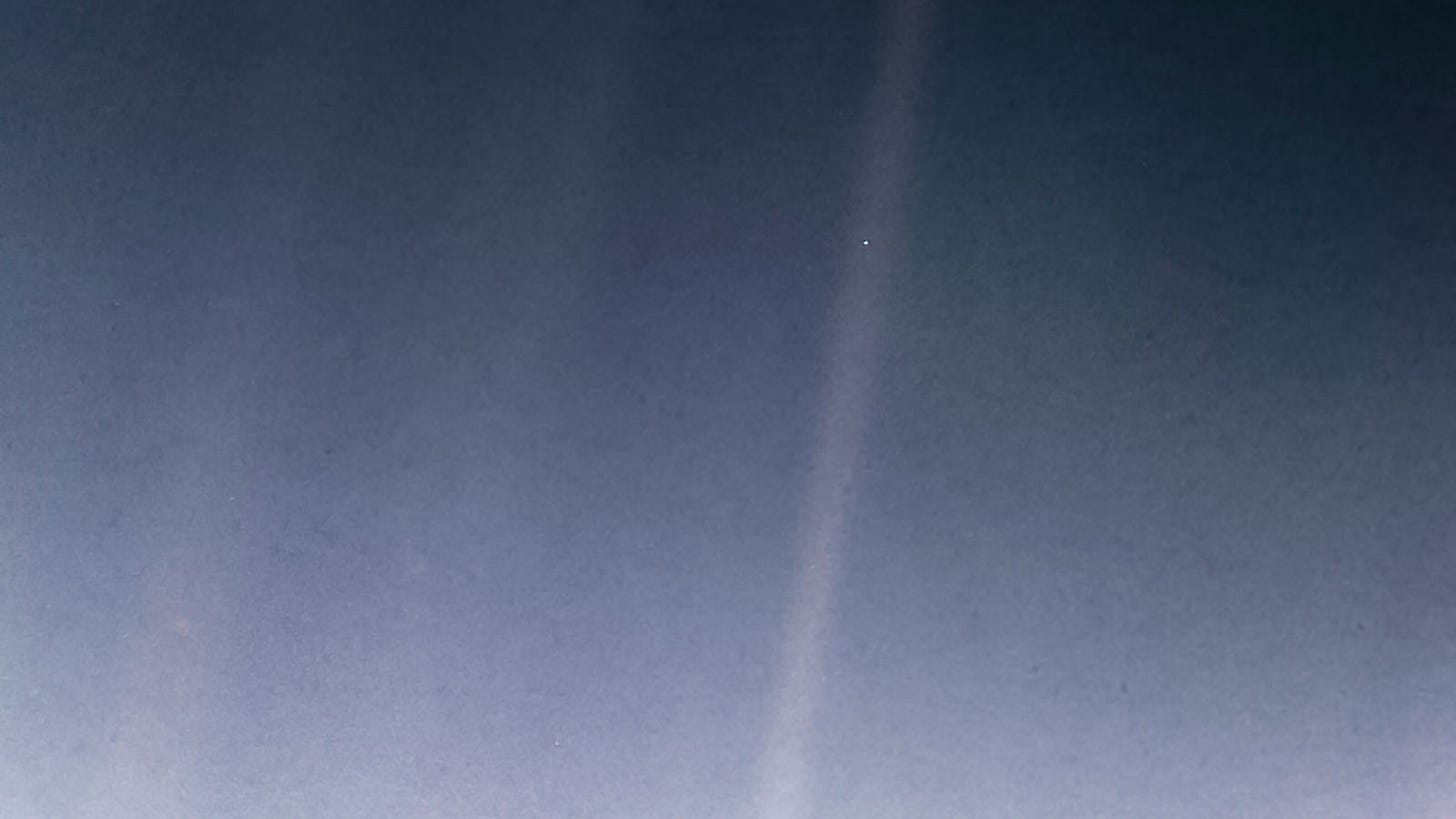 Earth as a small blue dot in a fuzzy beam of light.