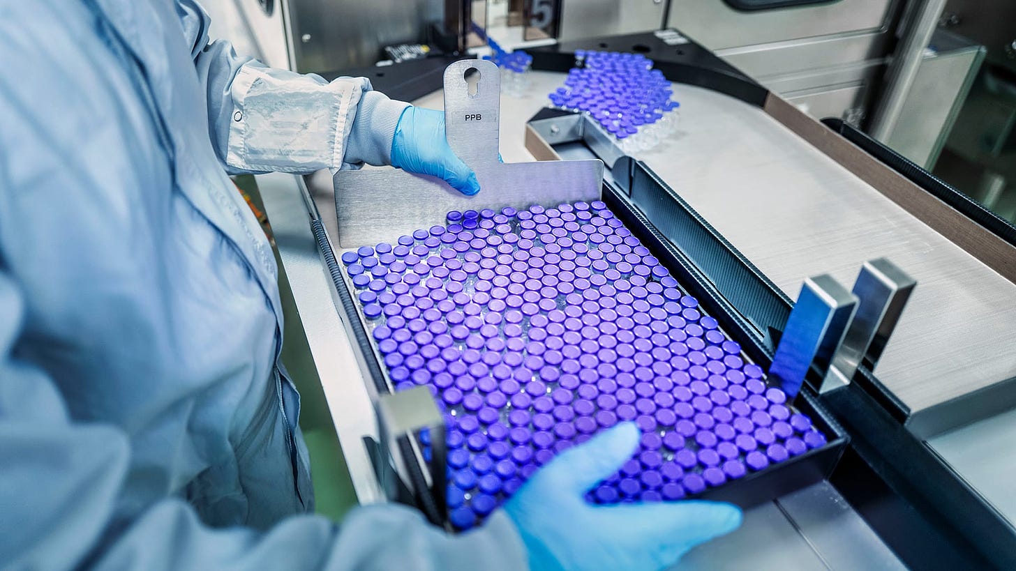 Looking over the shoulder: A batch of filled vaccine ampoules is packed for shipment 