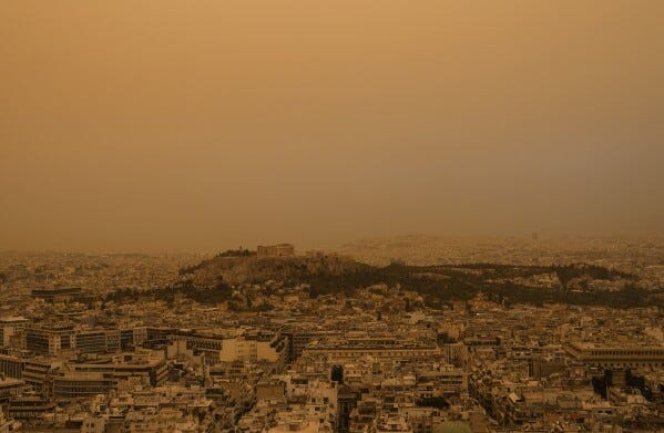 The ancient Acropolis hill and the city of Athens as it seen from the Lycabettus hill on Tuesday, April 23, 2024. The Acropolis and other Athens landmarks took on Martian hues Tuesday as stifling dust clouds blown across the Mediterranean Sea from North Africa engulfed the Greek capital.(AP Photo/Petros Giannakouris)