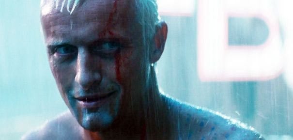 A still from the film Blade Runner, showing Rutger Hauer as the character Roy Batty. He is bloody, tired, and it is raining. He is ready to die.