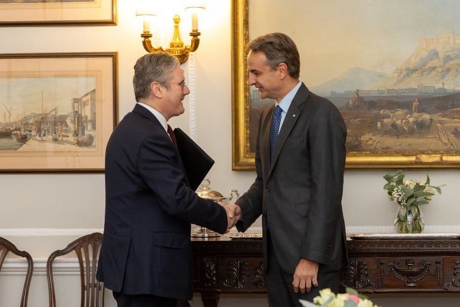 A photograph of Keir Starmer shaking hands with Greek Prime Minister Kyriakos Mitsotakis.