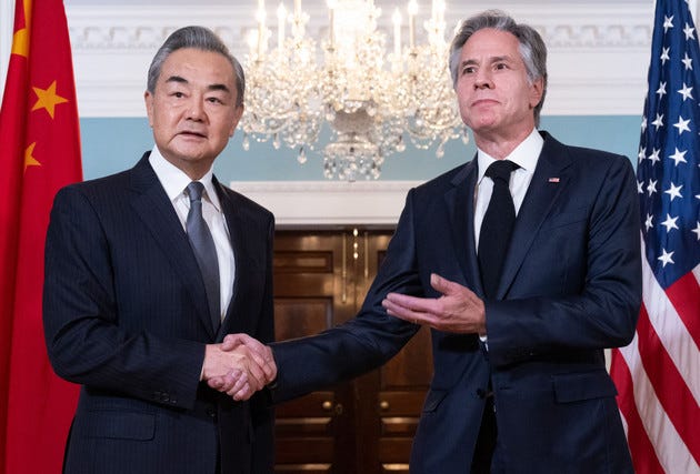 US Secretary of State Antony Blinken shakes hands with Chinese Foreign Minister Wang Yi prior to meetings at the State Department in Washington, DC.