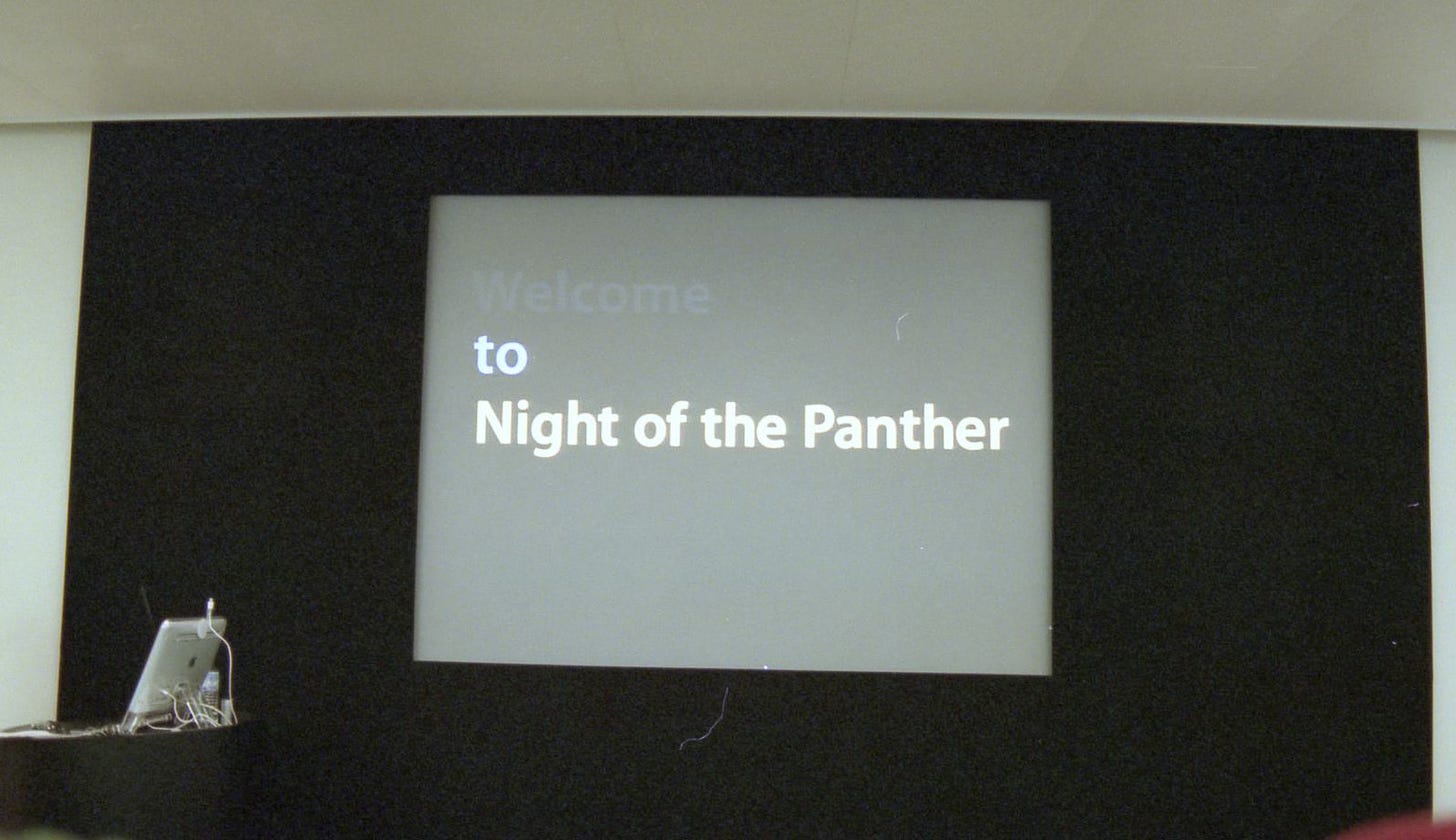 The Theater screen at Apple Palo Alto with a slide reading, "Welcome to Night of the Panther."