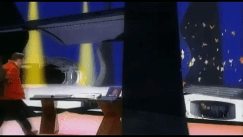 Chris and Lance jog into a separate room with a desk. It has Lance's computer from earlier, and the blonde woman with yellow jacket/orange pants is materializing on the far side.
