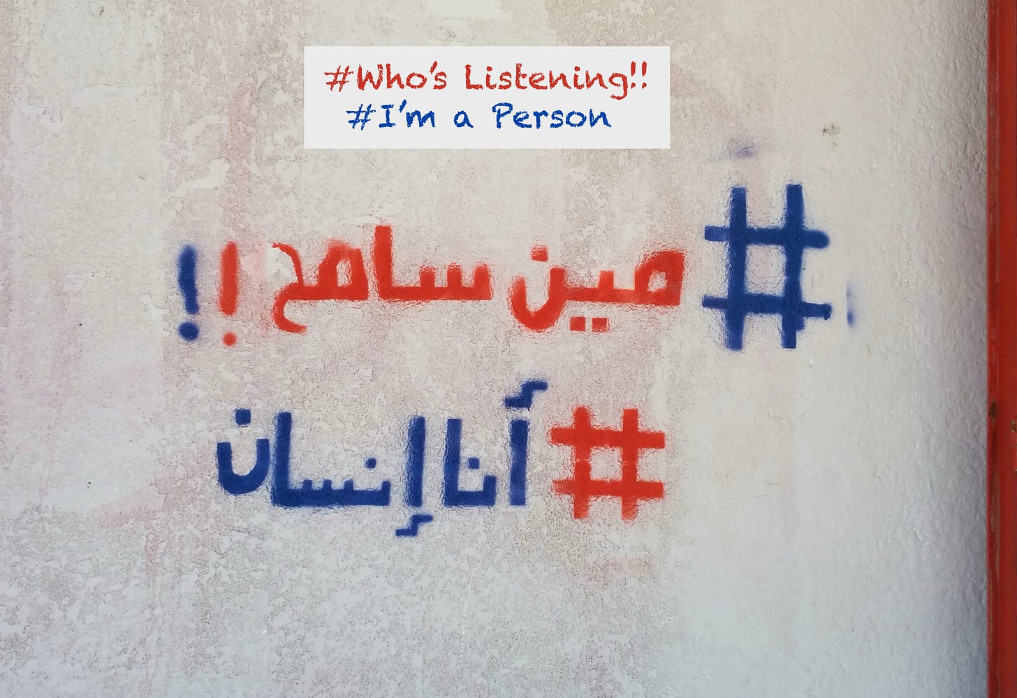 Arabic graffiti in red and blue with hashtags before each line