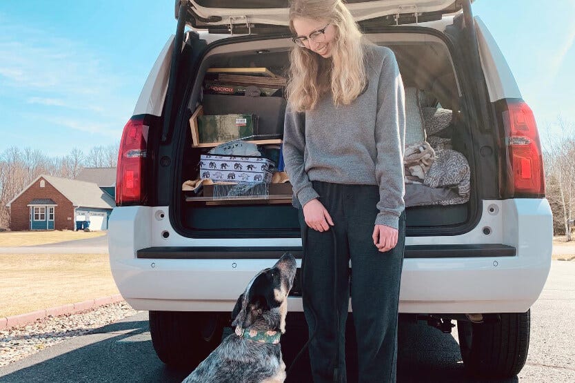 Scout the blue heeler all ready to move to Florida in front of the packed car