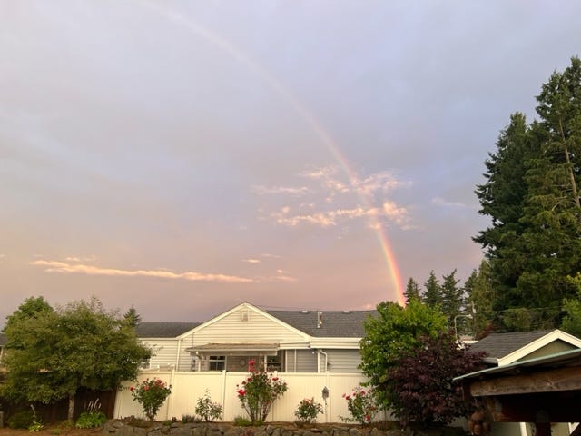 A rainbow over a house

Description automatically generated with medium confidence