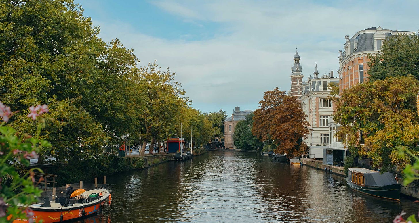 City along a canal with boats in the water.