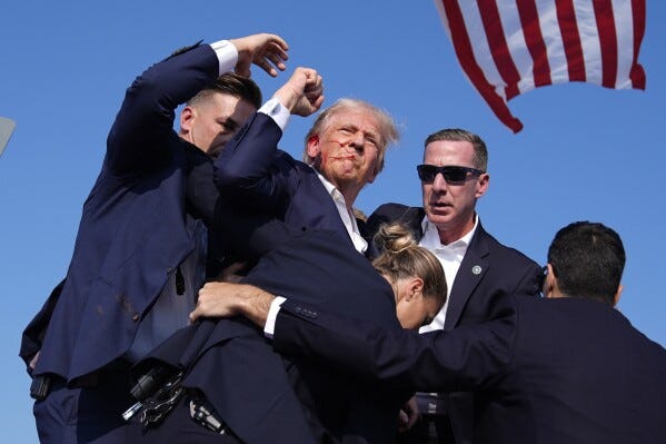 Trump raised his fist and projected an image of defiance | AP News