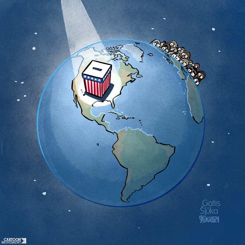 Cartoon showing the earth, with a giant ballot box standing on the US, with a spotlight on it. The world population is peeking over the rim of the world, anxiously awaiting the election outcome.