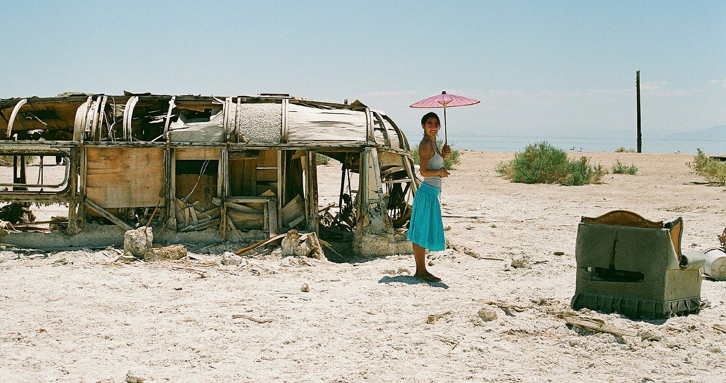 woman standing beside a derelict bus woman standing beside a derelict bus