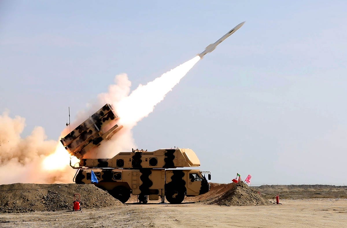 The theoretical war would start with conventional weapons including missiles (Pictured: A missile being launched during drills in Iran)
