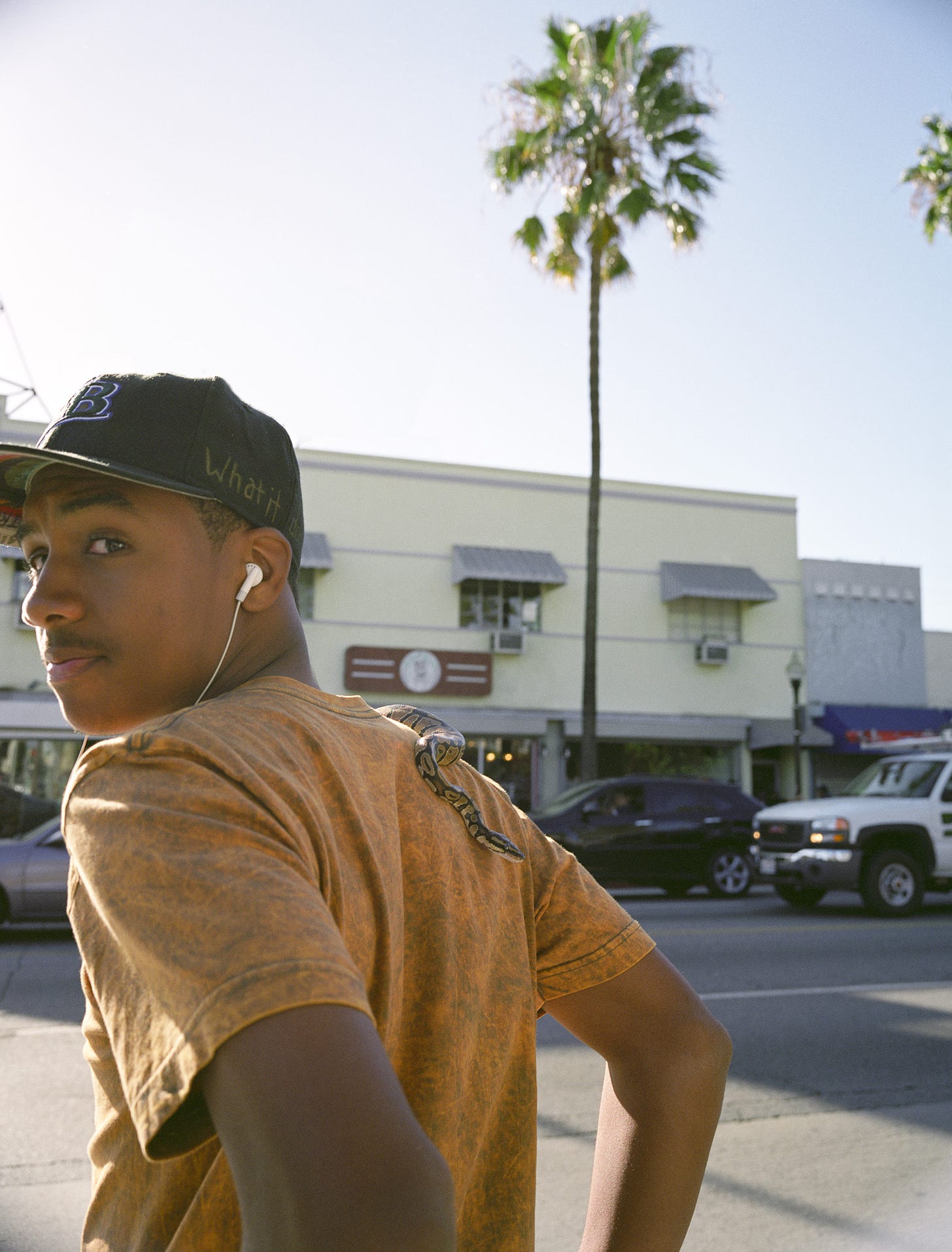 Photo of young man with snake, Fairfax District, Los Angeles