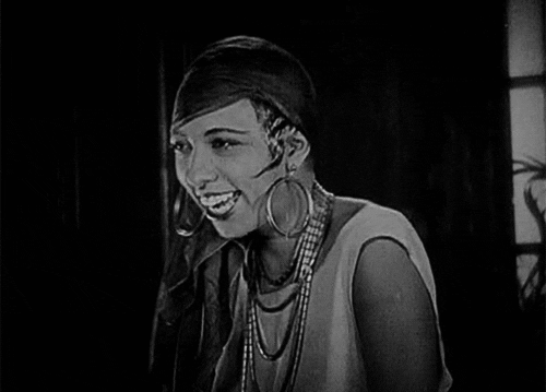 The beautiful Josephine Baker laughing heartily, throwing her head back.