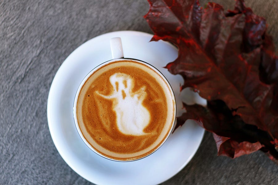 A cup of coffee with a ghostly figure A cup of coffee with a ghostly figure