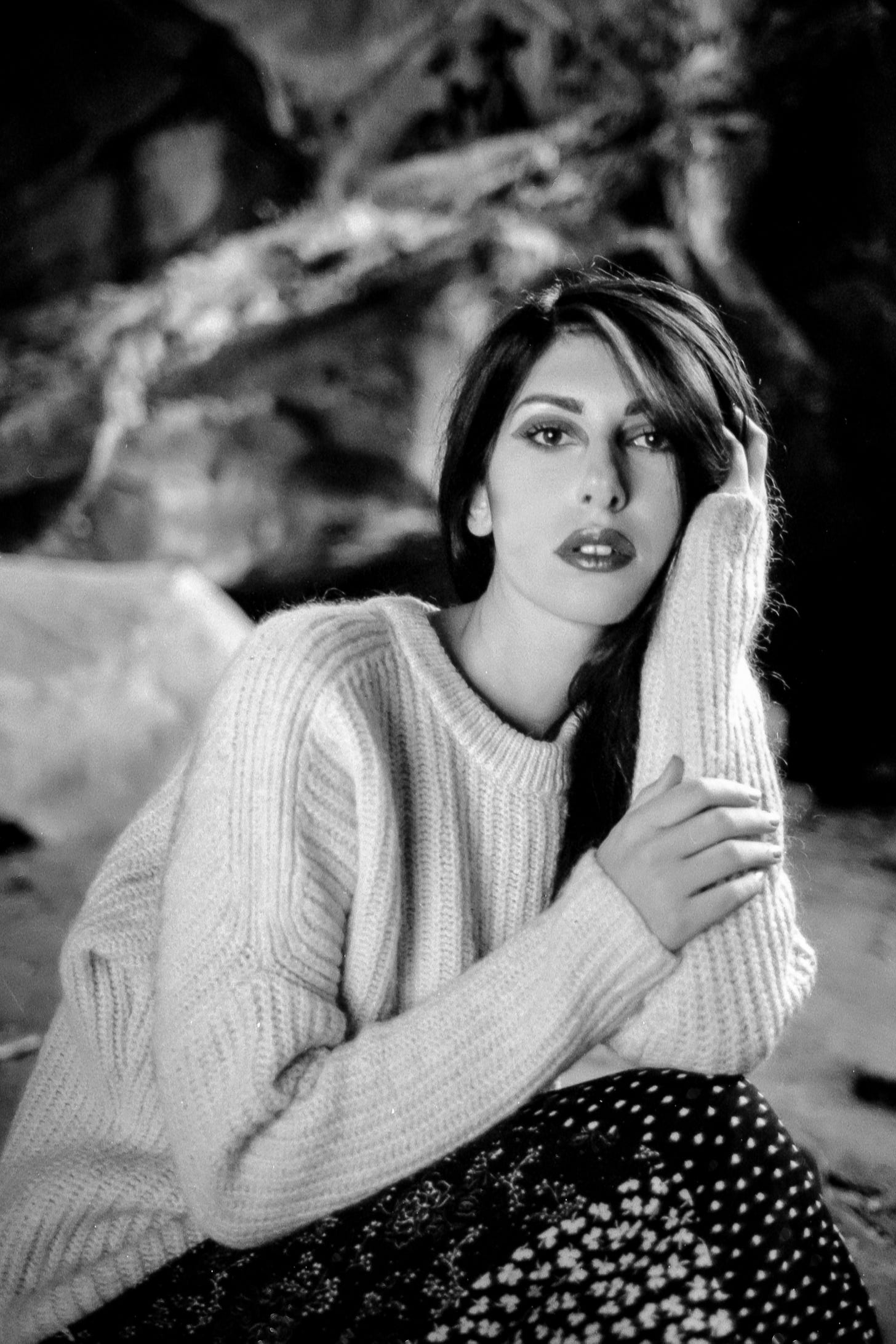 Black and white film portrait of brunette model with white sweater