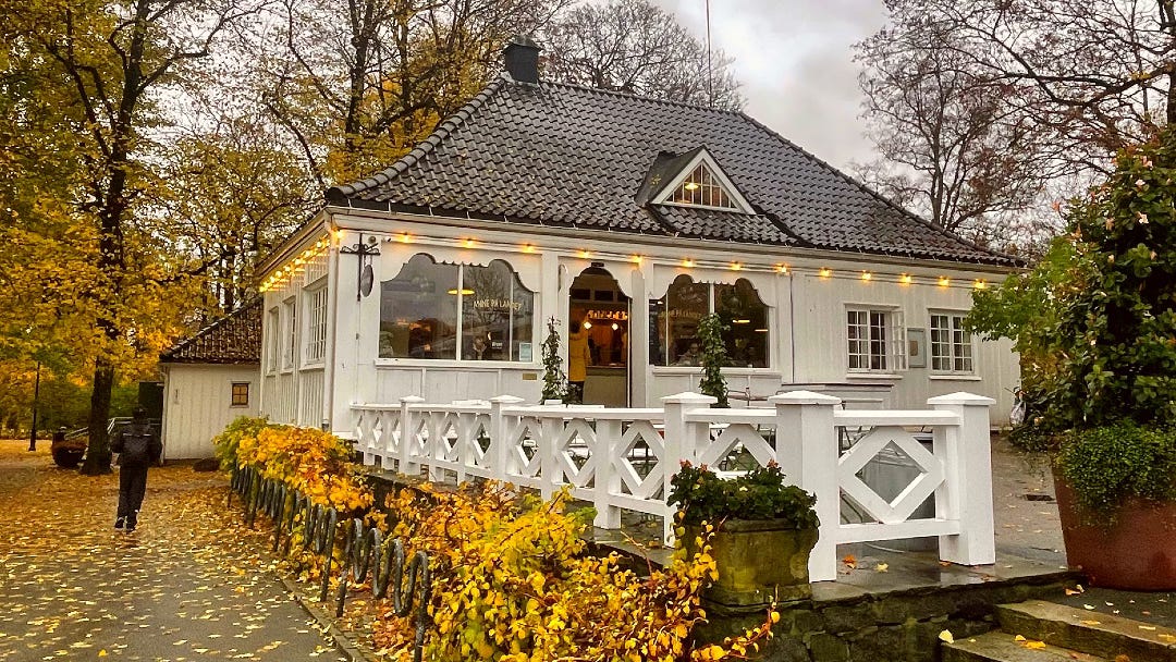 white, wooden, cafe in a park