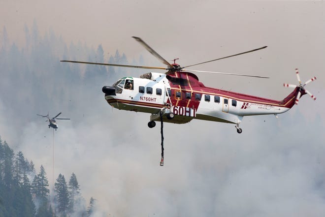 Helicopters make trips back and forth to water near McKenzie Bridge as firefighters try to get the upper hand on the Lookout Fire.