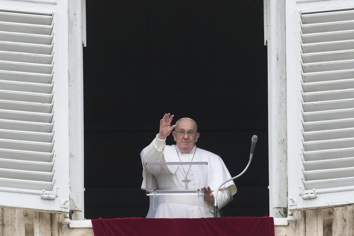 Pope Francis waves at the Vatican crowds.
